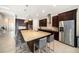 Gourmet kitchen with stainless steel appliances, granite countertops, a large island, and dark wood cabinets, perfect for cooking at 8016 Rock Spring Ct, Land O Lakes, FL 34638