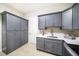 Spacious laundry room featuring cabinets, countertop space, sink, and storage at 8016 Rock Spring Ct, Land O Lakes, FL 34638