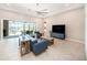 A spacious living room features stylish furniture and sliding glass doors to an outdoor seating area at 8016 Rock Spring Ct, Land O Lakes, FL 34638