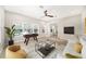Bright living room with a foosball table and view of the backyard pool at 8016 Rock Spring Ct, Land O Lakes, FL 34638