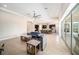 Bright living room with an open floor plan, large windows, and modern furnishings, seamlessly connected to the gourmet kitchen at 8016 Rock Spring Ct, Land O Lakes, FL 34638