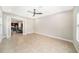 Spacious living room with tile floors, ceiling fan, and a view leading to a kitchen with a dining area at 8016 Rock Spring Ct, Land O Lakes, FL 34638