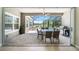 Outdoor patio features a ceiling fan, dining table, grill, and clear view of the pool and surrounding greenery at 8016 Rock Spring Ct, Land O Lakes, FL 34638