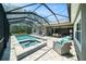Relaxing screened-in pool and hot tub with outdoor seating on a brick patio, perfect for entertaining at 8016 Rock Spring Ct, Land O Lakes, FL 34638