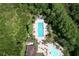 Aerial view of a community pool with lounge chairs and umbrellas surrounded by lush greenery at 8016 Rock Spring Ct, Land O Lakes, FL 34638