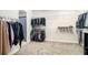 Walk-in closet with carpeting, and hanging racks for clothing and storage at 8016 Rock Spring Ct, Land O Lakes, FL 34638