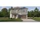 Charming two-story home featuring gray siding, a two-car garage, and a well-manicured lawn at 8778 Linked Dr, New Port Richey, FL 34655