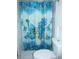Bathroom featuring a toilet and shower with a blue shower curtain at 8996 Southern Comfort Dr, Largo, FL 33773