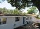 Exterior view of a single-story home with a stone accent wall and blue entry door at 8996 Southern Comfort Dr, Largo, FL 33773