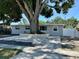 Charming one-story home with mature tree in front yard, brick facade, and newly paved walkway at 8996 Southern Comfort Dr, Largo, FL 33773