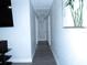 Hallway featuring gray flooring, neutral walls, and access to various rooms at 8996 Southern Comfort Dr, Largo, FL 33773