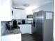 Modern kitchen with white cabinets, stainless steel appliances, and stylish backsplash at 8996 Southern Comfort Dr, Largo, FL 33773