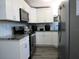 Well-lit kitchen featuring white cabinetry, stainless steel appliances, and granite countertops at 8996 Southern Comfort Dr, Largo, FL 33773