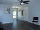 Spacious living room showcasing gray flooring, neutral walls, and a ceiling fan at 8996 Southern Comfort Dr, Largo, FL 33773