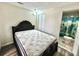 Main bedroom featuring a bed, ensuite bathroom, and modern flooring at 8996 Southern Comfort Dr, Largo, FL 33773
