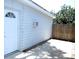 Exterior side view of property featuring white door and privacy fence at 8996 Southern Comfort Dr, Largo, FL 33773