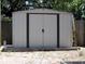 Exterior view of a modern metal storage shed in the backyard at 8996 Southern Comfort Dr, Largo, FL 33773