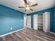 This bedroom includes laminate flooring, an open closet, and access to a bathroom at 9292 120Th Ln, Seminole, FL 33772