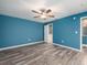 Bright bedroom featuring laminate flooring, ceiling fan, and a ensuite bathroom at 9292 120Th Ln, Seminole, FL 33772