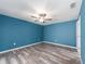 Bedroom with fresh paint, ceiling fan, and luxury vinyl plank flooring at 9292 120Th Ln, Seminole, FL 33772