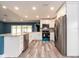 Modern kitchen featuring white cabinets, granite countertops, stainless steel appliances, and wood floors at 9292 120Th Ln, Seminole, FL 33772