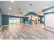 Open-concept living space featuring wood floors, a ceiling fan, and a seamless transition to the kitchen at 9292 120Th Ln, Seminole, FL 33772