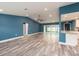 Spacious living area with vaulted ceiling, open floor plan, wood floors, and a sliding glass door at 9292 120Th Ln, Seminole, FL 33772