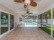 Covered patio area overlooking a screened pool, perfect for outdoor relaxation at 9292 120Th Ln, Seminole, FL 33772