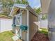 Charming shed with a decorated door, window box, and flower pots adds character to the property at 9292 120Th Ln, Seminole, FL 33772