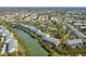 Beautiful aerial view of condos lining a calm waterway surrounded by mature trees and neighborhood at 9812 Indian Key Trl # 84, Seminole, FL 33776