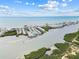 Scenic aerial view of beachfront condos, a sandy beach, and serene blue ocean waters at 9812 Indian Key Trl # 84, Seminole, FL 33776