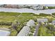 Aerial view of the waterfront community surrounded by water, trees, and lush landscaping at 9812 Indian Key Trl # 84, Seminole, FL 33776