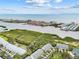 A high-angle view showcasing the layout of the townhome community with waterway views and lush greenery at 9812 Indian Key Trl # 84, Seminole, FL 33776