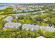 Aerial view of the townhomes and community, featuring a pool and mature landscaping at 9812 Indian Key Trl # 84, Seminole, FL 33776