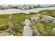 An aerial view of the waterfront community, surrounded by water, trees, and lush landscaping at 9812 Indian Key Trl # 84, Seminole, FL 33776