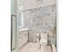 Modern bathroom with blue stone tiled wall, sleek vanity, and glass enclosed shower at 9812 Indian Key Trl # 84, Seminole, FL 33776