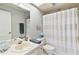 Cozy bathroom featuring a shower and tub combo, vanity and toilet at 9812 Indian Key Trl # 84, Seminole, FL 33776