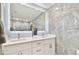 Elegant bathroom featuring an illuminated mirror, double sinks, and modern tiling at 9812 Indian Key Trl # 84, Seminole, FL 33776