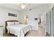 Airy bedroom featuring a woven headboard and ensuite bathroom and hallway access at 9812 Indian Key Trl # 84, Seminole, FL 33776