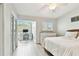 Inviting bedroom featuring a desk area, shutters, ceiling fan and wood-look floors at 9812 Indian Key Trl # 84, Seminole, FL 33776