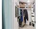 Organized walk-in closet with hanging clothes and shelving for accessories at 9812 Indian Key Trl # 84, Seminole, FL 33776
