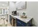 Convenient coffee bar with marble countertop, stainless steel mini-fridge, and custom cabinets at 9812 Indian Key Trl # 84, Seminole, FL 33776