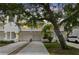 Inviting exterior showcasing well-maintained townhomes with garages and mature trees, creating a serene street view at 9812 Indian Key Trl # 84, Seminole, FL 33776