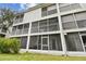 Exterior view of screened balconies with white railings at 9812 Indian Key Trl # 84, Seminole, FL 33776