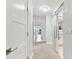Hallway featuring carpet, white walls, modern doors, and a glass sliding door at 9812 Indian Key Trl # 84, Seminole, FL 33776
