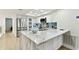 A spacious kitchen with white cabinets, stainless steel appliances, and a marble island at 9812 Indian Key Trl # 84, Seminole, FL 33776