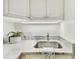 A close-up of a modern kitchen sink featuring stylish fixtures and bright marble countertops at 9812 Indian Key Trl # 84, Seminole, FL 33776