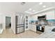 Modern kitchen with stainless steel appliances, white cabinetry, and a functional layout, offering ample storage and counter space at 9812 Indian Key Trl # 84, Seminole, FL 33776
