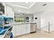 Bright kitchen features stainless steel appliances, sleek countertops, open layout seamlessly connected to the living area at 9812 Indian Key Trl # 84, Seminole, FL 33776
