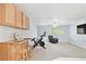 Cozy living area with a bar seating, fitness equipment, a comfortable recliner, and natural lighting at 9812 Indian Key Trl # 84, Seminole, FL 33776